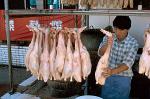 man preparing ducks at a local restaurant
