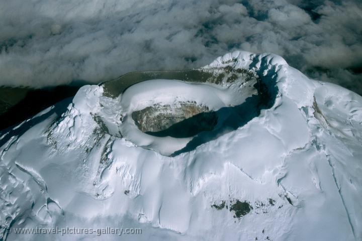 snow-capped Cotopaxi volcano crater from the air (5,897 m)