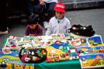 kids selling souvenir textiles