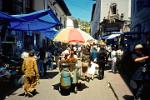 a busy street market in downtown Quito