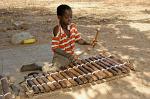 boy playing a marimba at Wassu