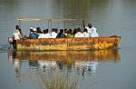 a small boat with people crossing the river