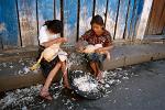 girls plucking chicken in Chichicastenango