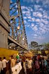 people crossing Howrah Bridge over the Hooghly River