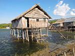 houses on stilts in a sea gypsy village on the coast