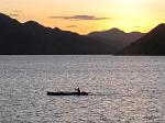canoe passing at sunset
