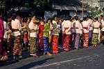 traditionally dressed people in an offering ceremony