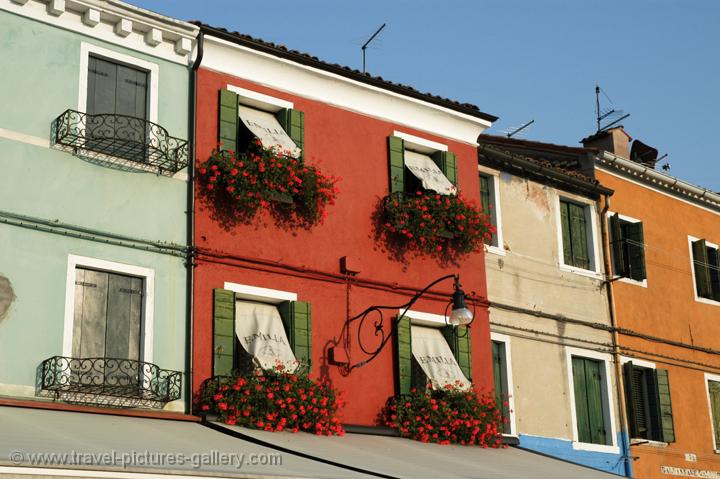 geraniums hanging from the windows