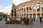 group of tourists posing with the Colosseum