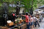 kids pooring water over statues, mausoleum of Kobo Daishi