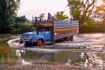truck crossing a shallow river