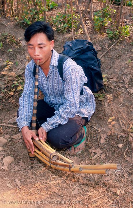 young man playing a bamboo flute
