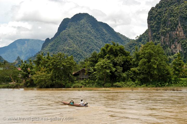 longtail boat on the Nam Song River, limestone hills