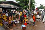 women selling fruit and shoes at the market