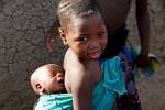 little girl with a baby on her back