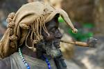 a man of the Dogon People Tribe smoking a pipe