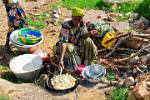 woman frying dumplings at Dourou market