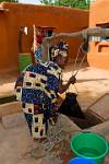 woman fetching water from a well