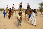 tourists on a camel trip in the surrounding desert