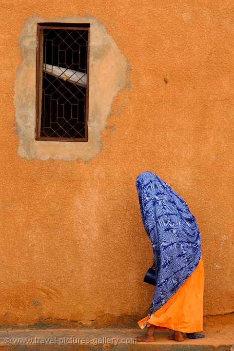 ochre wall and colourful dress