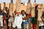 Quran lessons, boys writing texts on planks