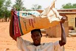 man carrying a bag of powder milk