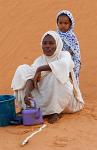 a woman and her daughter, edge of the desert