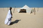 Bedouin man and tent, desert landscape