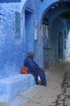 resting woman in a Kasbah street