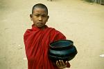 young monk with his alms begging bowl