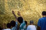 people worshipping at the Golden Rock, Kyaiktiyo Pagoda