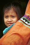 indian girl hiding behind her mother's dress