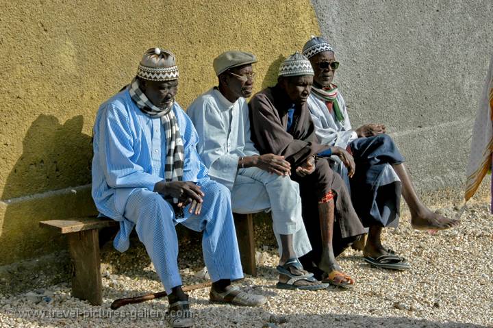 elderly men sitting on a bench
