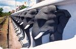 a row of sculpted elephants at Ruvanvelisaya Dagoba