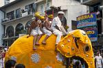 four boys riding an elephant