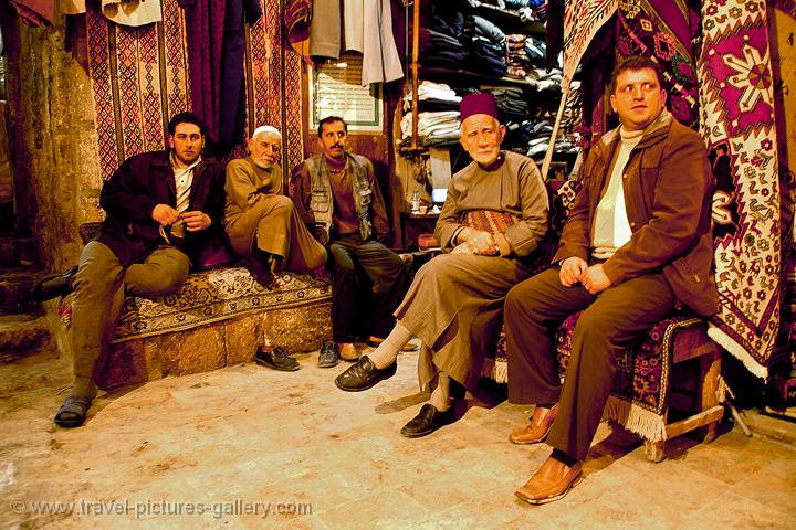 Aleppo, men relaxing in the carpet souq
