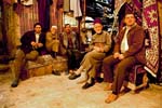 Aleppo, men relaxing in the carpet souq