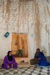 local women inside a mud brick house