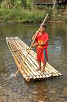 man on a bamboo raft, trekking near Kanchanaburi