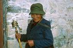 a woman turning a prayer wheel