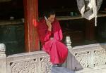 monk chatting on a mobile phone