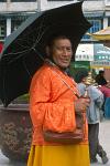 a pilgrim with a prayer wheel and umbrella