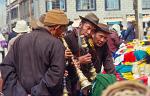 men trying traditional horns at the Barkhor Bazaar