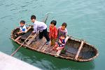 local kids in a traditional bamboo boat