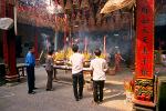 people worshipping at a Cholon temple
