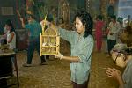 a woman releasing birds at a Cholon temple