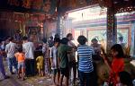 people worshipping at a Cholon temple