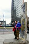 posing at a Berlin Wall memorial