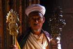 a priest holding crosses in one of Lalibela's rock hewn churches