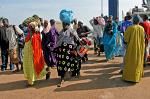 people leaving the Banjul ferry wearing traditional dress